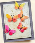Colorful butterfly embellishments on a card made with Six Piece Rectangle Frame Metal Die Cuts Set With Scalloped Stitch Nested Tags.