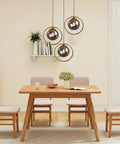 Industrial Vintage 3 Light Pendant Lighting Fixture With Brass Ring And Glass Globe Shades in dining room setting