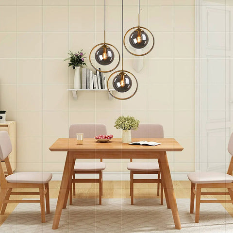 Industrial Vintage 3 Light Pendant Lighting Fixture With Brass Ring And Glass Globe Shades in dining room setting
