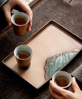 Premium Ceramic Tea Serving Tray For Kung Fu Brewing And Coffee Or Cocktails with tea cups in hand on wooden table