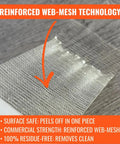 Close-up of Double Sided Carpet Tile Tape 2 In By 90 Ft Heavy Duty With Reinforced Web Mesh on wood surface.