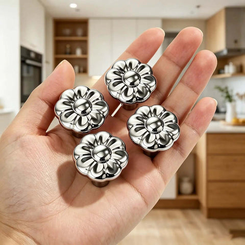 Hand holding Chrome Flower Drawer Knob Set Zinc Cabinet Pulls 4 Pack with durable chrome finish in kitchen setting.