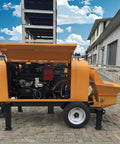Powerful Portable Concrete Pump Machine With Advanced Hydraulic Drive System For Efficient Construction Site Material Transfer And Heavy Duty Conveying Solutions In Professional Settings, side view with engine exposed.