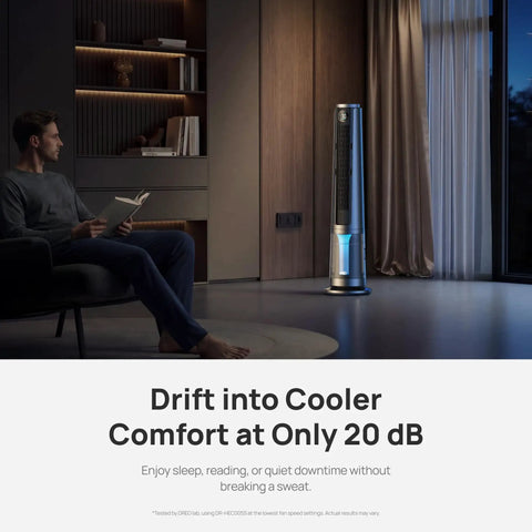 A man reading beside the TurboCool Misting Fan 765S Ultrasonic Cooling Tower for Beat The Heat Fast in a living room setting.