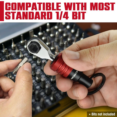 Hands holding EDC Mini Ratchet Wrench with One Quarter Inch Hex End and Bit Holder for Quick Bit Changes near a tool set.
