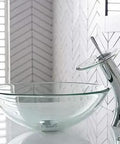 Clear Glass Vessel Sink With Waterfall Faucet Combo Set In Chrome Finish on modern bathroom countertop