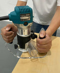 Game Changing Clear Acrylic Router Base Plate Compatible With RT0701C And XTR01Z 6 By 10 Inch Wide Base in use with hands gripping handles.