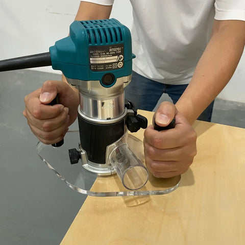 Game Changing Clear Acrylic Router Base Plate Compatible With RT0701C And XTR01Z 6 By 10 Inch Wide Base in use with hands gripping handles.