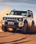 Off-road vehicle driving across desert with Mountain License Plate Frame Set For Cars And Trucks With Dope 3D Raised Mountain Design