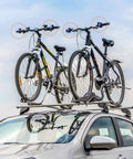 Cars with two bicycles secured using 8 pack bike rack straps with adjustable stabilizers, 8 inch and 26 inch lengths on roof rack.