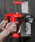 Close-up of Heavy Duty Electric Wall Planer To Kick Back Dust with dual handle grip, showing hands operating the tool.