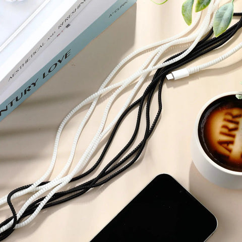 Ten Pack Spiral Cable Protectors For Pets Chew Proof USB Cables And Phone Chargers 110 Cm Black Sleeve shown with black and white cables