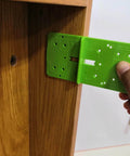Hand using 35mm Hinge Template Router Jig For Cabinets Drawers And Furniture Doors With Pro Grade Durable Aluminum Guide And Adjustable Stops Precision Concealed Hinge Boring Jig For Woodworking Installations on wooden cabinet frame.