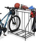 Three Bike Stand Rack For Garage Storage And Indoor Outdoor Use, Adjustable Slots Fits Mountain, Hybrid, And Kids Bikes With 4.2 Inch, 2.5 Inch, And 1.2 Inch Widths, Holds Three Bicycles Securely, shown with a bike and sports equipment.