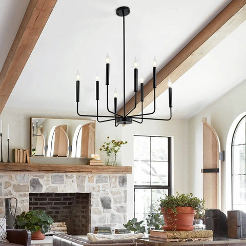 8-Light Modern Black Farmhouse Chandelier With Industrial Metal Arms And Candle-Style Cups in rustic living room.