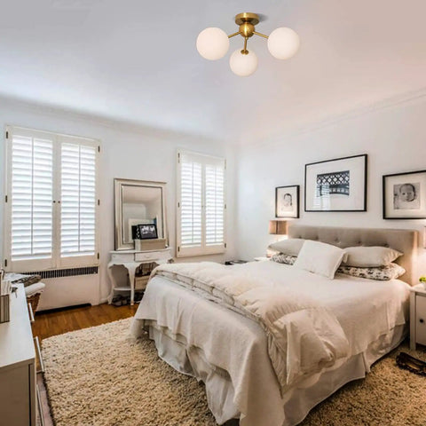3 Light Modern Globe Ceiling Light Mid Century Sputnik Chandelier With White Glass Shades Brushed Brass Finish in bedroom.