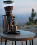Barista Level Electric Coffee Grinder With Stepless Control And 54Mm Steel Flat Burrs delivers consistent grounds on a stylish table.