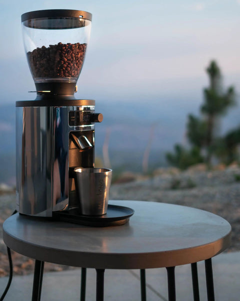 Barista Level Electric Coffee Grinder With Stepless Control And 54Mm Steel Flat Burrs delivers consistent grounds on a stylish table.