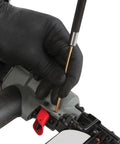 Close-up of Brass Roll Pin Punch Set With Knurled Steel Handles 8 Inch 5 Piece used on machinery by gloved hand