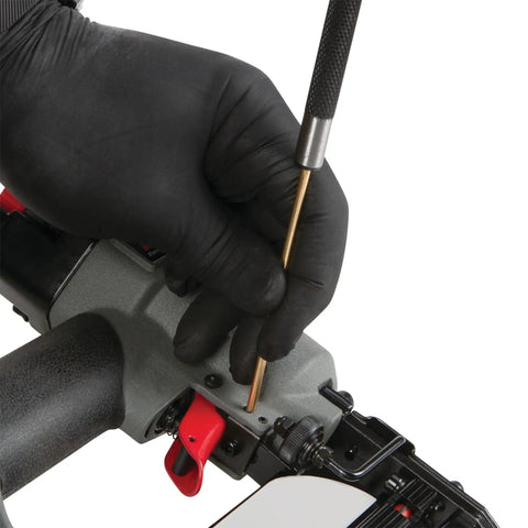 Close-up of Brass Roll Pin Punch Set With Knurled Steel Handles 8 Inch 5 Piece used on machinery by gloved hand