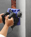 Hands operating the Heavy Workhorse 1300W Handheld Wall Planer against a concrete wall, showcasing its 6 inch wide blade.