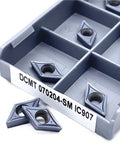 Premium Indexable Carbide Lathe Tool DCMT070204 IC907 inserts displayed in a gray storage tray for metal working.