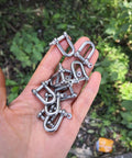 Hand holding 10 Stainless Steel Mini D Shackle 4mm For Paracord Jewelry And Everyday Outdoor Gear, marine-grade 316 hardware