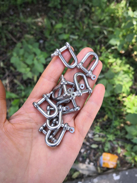 Hand holding 10 Stainless Steel Mini D Shackle 4mm For Paracord Jewelry And Everyday Outdoor Gear, marine-grade 316 hardware