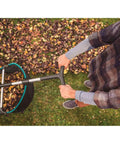 Man using Durable Lawn Sweeper For Leaves And Grass Clippings, No Fuss Maneuvering 3.2 Cu Ft Mesh Hopper on autumn lawn