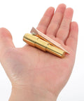 Hand holding golden metal chuck of Spot Weld Dent Puller Kit With Metal Chuck For Car And Sheet Metal Repair High Efficiency Auto Body Tool For Precise Dent Removal And Rugged Pro Grade Auto Body Restoration