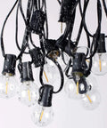 Close-up of Outdoor String Lights 300Ft Led Waterproof Connectable G40 Globe Patio Lights With 156 Shatterproof Plastic Bulbs wet with droplets