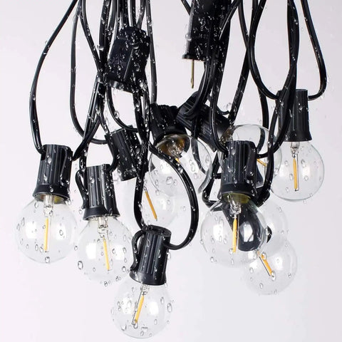 Close-up of Outdoor String Lights 300Ft Led Waterproof Connectable G40 Globe Patio Lights With 156 Shatterproof Plastic Bulbs wet with droplets
