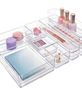 SimpleSort 10 Piece Stackable Clear Drawer Organizer Set with Multi Size Trays filled with makeup and office supplies