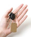 Rock Solid Large Grid Weave Jute Texture Rectangle Plated Metal Keychain built tough in hand with car keys, 2x1.1 inch size.