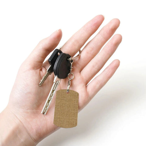 Rock Solid Large Grid Weave Jute Texture Rectangle Plated Metal Keychain built tough in hand with car keys, 2x1.1 inch size.