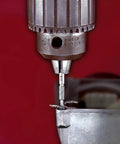 Grabit Micro 4 Piece Bolt And Screw Extractor Kit for tiny stripped fasteners in use on metal surface with drill