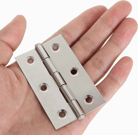 Close-up view of a stainless steel 3-inch door hinge held in hand, with six mounting holes and polished finish.