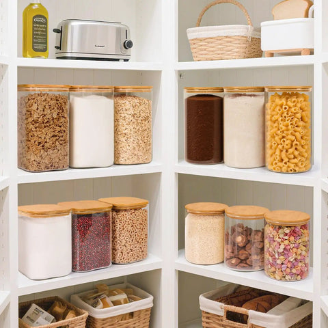 Two Pack 3.6 Qt Square Glass Food Storage Jars With Lids A Kitchen Must Have For Flour Sugar Rice Pasta Oats Coffee Beans Keeps Your Pantry Organized And Fresh Clear See Through Design, neatly arranged on white pantry shelves filled with various dry goods.
