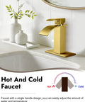 Gold waterfall spout single handle bathroom faucet in modern design on white sink with decorative vases.