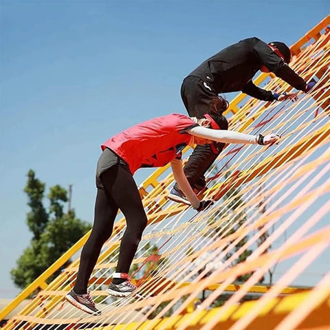 People climbing on a Heavy Duty Cargo Hoisting Net For Industrial Lifting And Transport Built Rugged For Safe Hauls Tear Resistant Polyester Sling