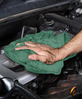 Person using Heavy Duty Shop Towels 50 Pack Green Terry Cloth Rags For Car Detailing And Home Cleaning Highly Absorbent Reusable Washable Towels on engine