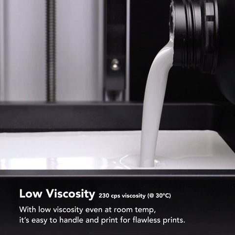 Close-up of white Ceramic Pro Resin for 3D printing pouring into a tray, showcasing ultra low viscosity for precise printing.
