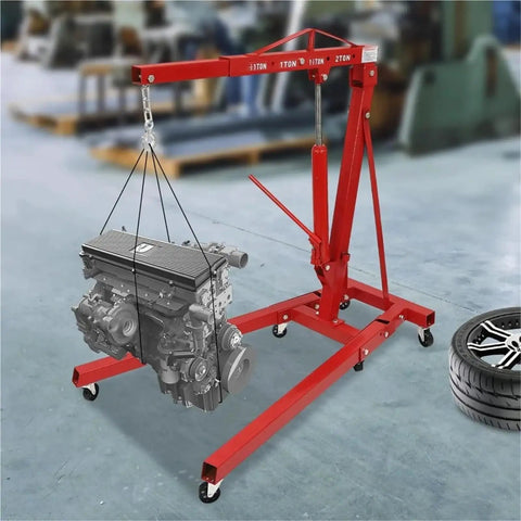 Heavy Duty Garage Workhorse: 2 Ton Hydraulic Engine Hoist With Adjustable 0.5 To 2T Range lifting an engine in a workshop.