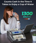Money Counter Machine With Value Count And Counterfeit Detection For Dollar And Euro Bills on desk with woman drinking water