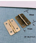 Two antique bronze mini hinges with dimensions, part of the Forty Two Piece Antique Bronze Mini Iron Hinges Set With Rounded Corners In A Sturdy Wooden Gift Box.