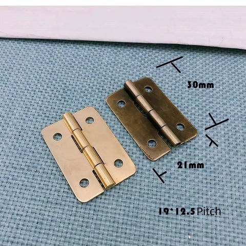 Two antique bronze mini hinges with dimensions, part of the Forty Two Piece Antique Bronze Mini Iron Hinges Set With Rounded Corners In A Sturdy Wooden Gift Box.