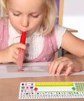 Child using a 40 Pack Transparent Self Adhesive Nameplate Pocket 14.5 by 4.5 Inch for Desk Name Tags with ruler and guide.