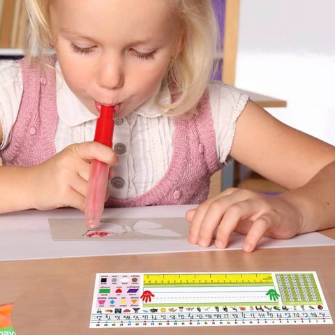 Child using a 40 Pack Transparent Self Adhesive Nameplate Pocket 14.5 by 4.5 Inch for Desk Name Tags with ruler and guide.