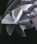 Close-up of carbide end mill with 6 flutes and a 1/4" shank.
