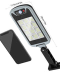 Lit Up Solar Flood Lights Outdoor With 168 LED 6500K Dusk Till Dawn Eight Sided Motion Sensor next to smartphone
